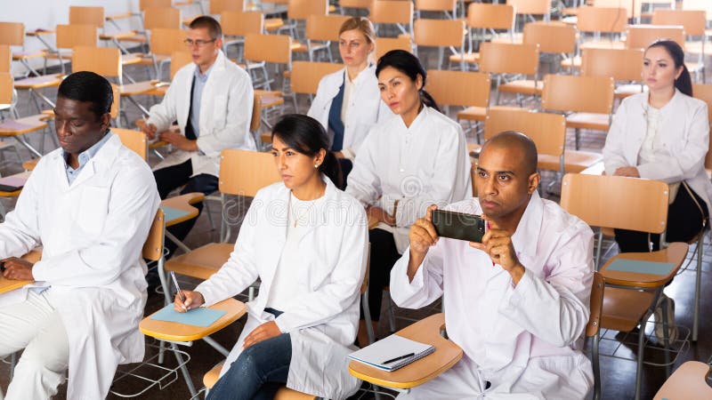 People listening to lecture at medical conference stock photos