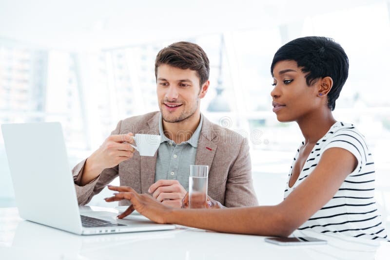 Multiethnic group of young business people having brainstorm in office