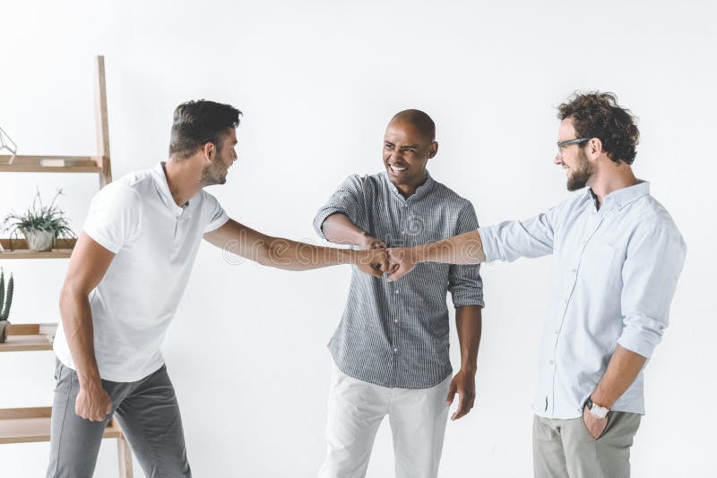 multiethnic group of young businessmen holding stock images multiethnic group of young businessmen holding stock images