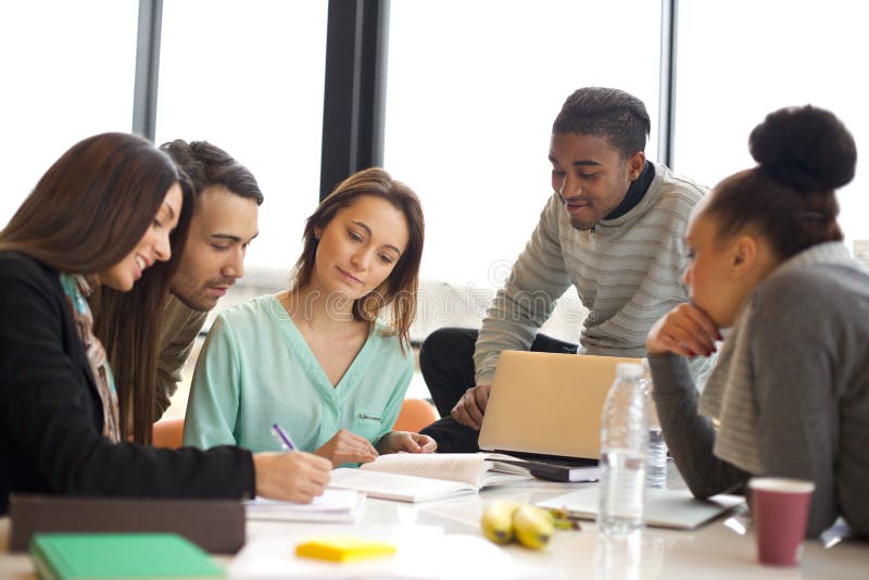 Multiethnic group of young people studying together stock photo