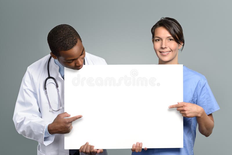 Multiethnic medical team holding a white sign