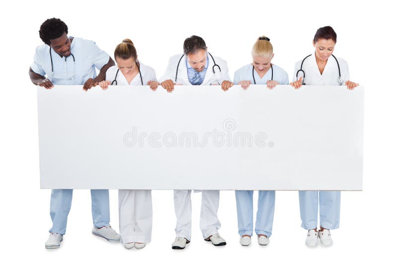 Multiethnic medical team looking at blank billboard