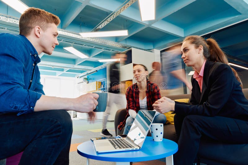 Multiethnic startup business team on meeting in a modern bright open space coworking office. Brainstorming, working on royalty free stock photography