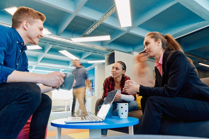 Multiethnic startup business team on meeting in a modern bright open space coworking office. Brainstorming, working on stock photography