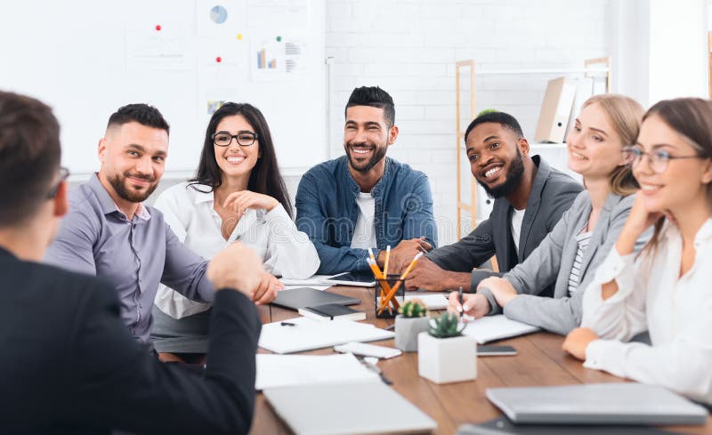 Multiethnic team listening to leader speaking at meeting stock image Multiethnic team listening to leader speaking at meeting stock image
