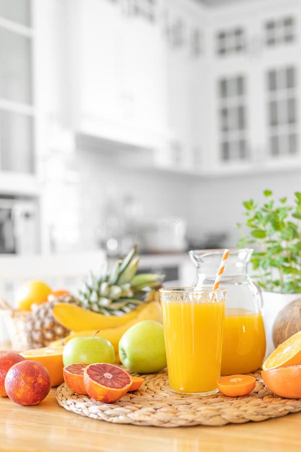 Multifruit Juice and Fresh Fruit on Table on Kitchen Background Stock