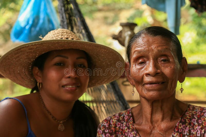 BriBri, Limon province, Costa Rica - March 17, 2016: grand daughter and grand mother from the ethnicity BriBri from Costa Rica looking at camera. BriBri, Limon province, Costa Rica - March 17, 2016: grand daughter and grand mother from the ethnicity BriBri from Costa Rica looking at camera