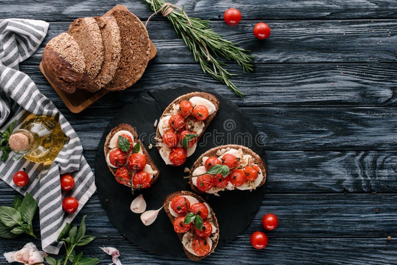 Multigrain Bread with Mozzarella and Baked Tomatoes on on Dark Stock