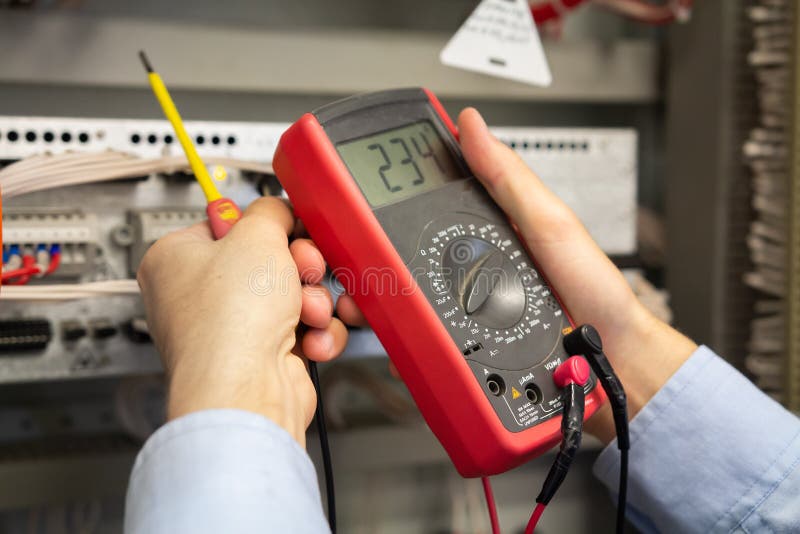 Multimeter in electrician hands stock photography