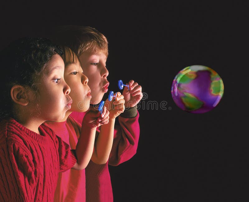 Multinational children blowing bubble