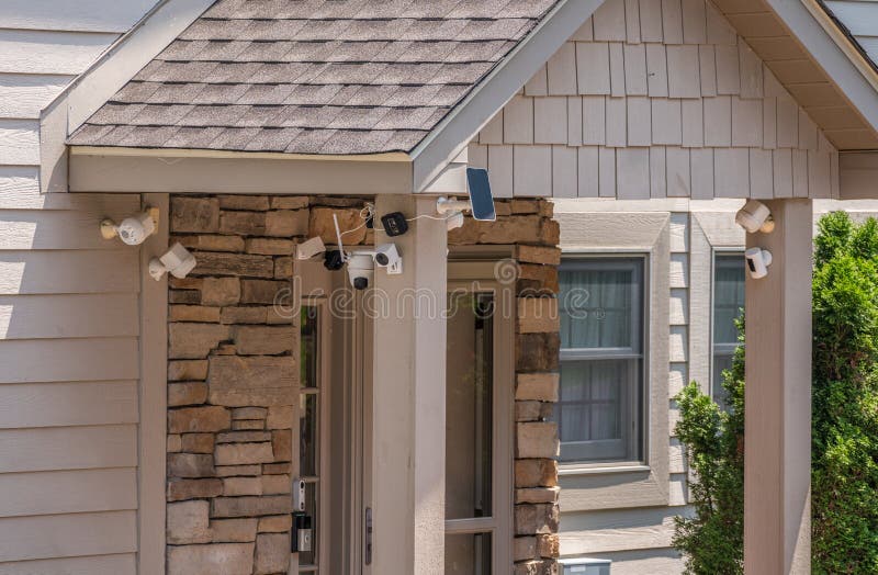 Multiple cameras and sensors securing front door of home royalty free stock photos