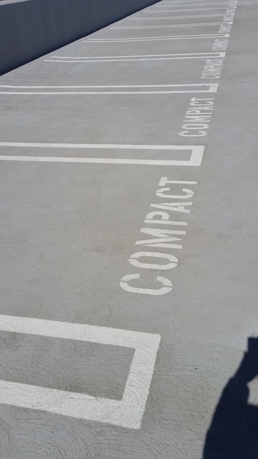 Multiple Empty Compact Parking Spaces on Concrete or Asphalt Parking