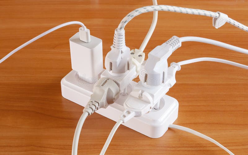 Multiple Plugs on Table Electrical Outlet is Dangerous Overload, Close