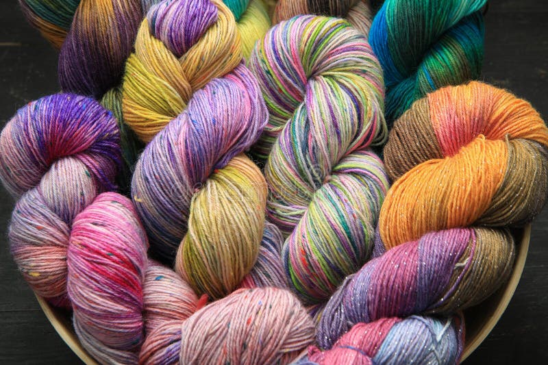 Multiple skeins of colourful handdyed sock yarn, sock wool, with extreme vibrant colours for knitting socks and other craft projects as a hobby. Multiple skeins of colourful handdyed sock yarn, sock wool, with extreme vibrant colours for knitting socks and other craft projects as a hobby.