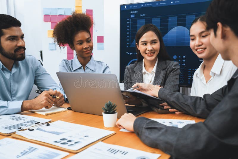 Multiracial analyst team use BI dashboard for data analysis with laptop. Concord stock photo