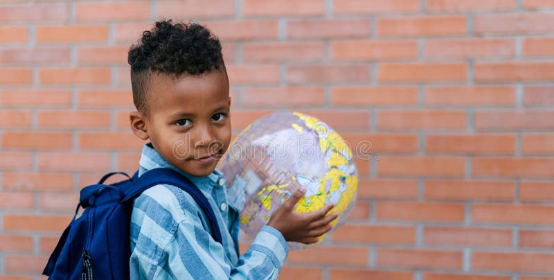 Multiracial boy playing outdoor with beach ball.