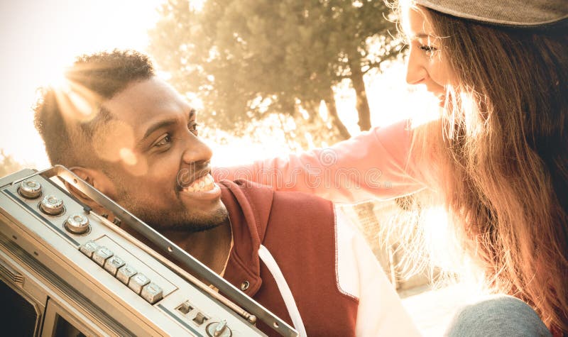 Multiracial couple at beginning of love story listening music