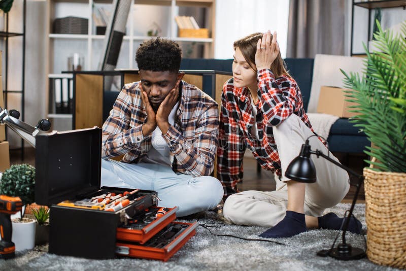 Multiracial family assembling furniture at new home alone royalty free stock image