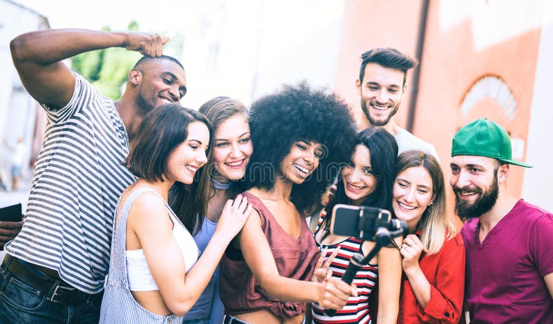 Multiracial friends taking video selfie with mobile phone on stabilized gimbal - Young people having fun on new tech trends