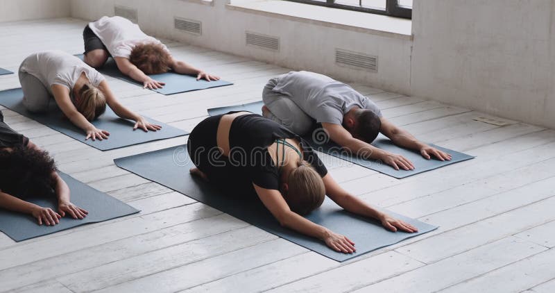 Three young fitness girls holding yoga mat while standing in gym Stock  Photo - Alamy