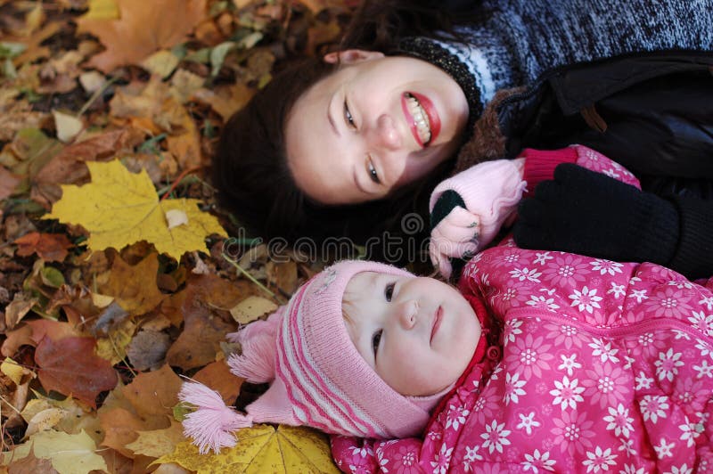 Mum with a daughter in autumn park