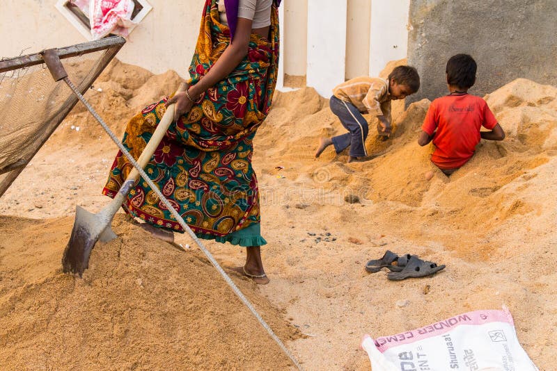 Poor mum forced to work to feed her family children playing in background. Poor mum forced to work to feed her family children playing in background