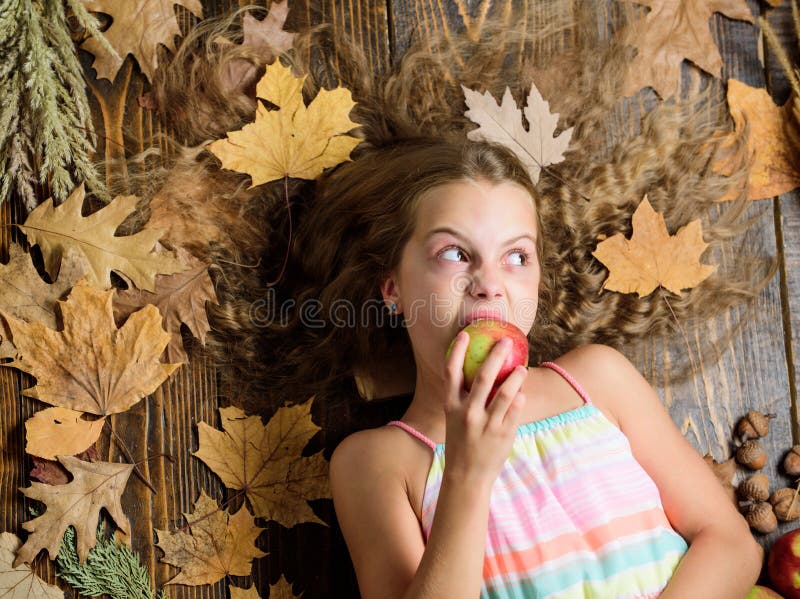 Munch, crunch. Vitamin food for healthy growth. Cute girl child with ripe autumn crops. Little girl biting apple. Small stock photos Munch, crunch. Vitamin food for healthy growth. Cute girl child with ripe autumn crops. Little girl biting apple. Small stock photos