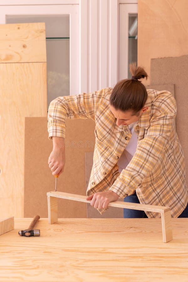 Muncitor cu șurubelniță pentru fabricarea mobilei. tâmplar masculin cu fațete decupate cu șurubelniță în scânduri din lemn royalty free stock image