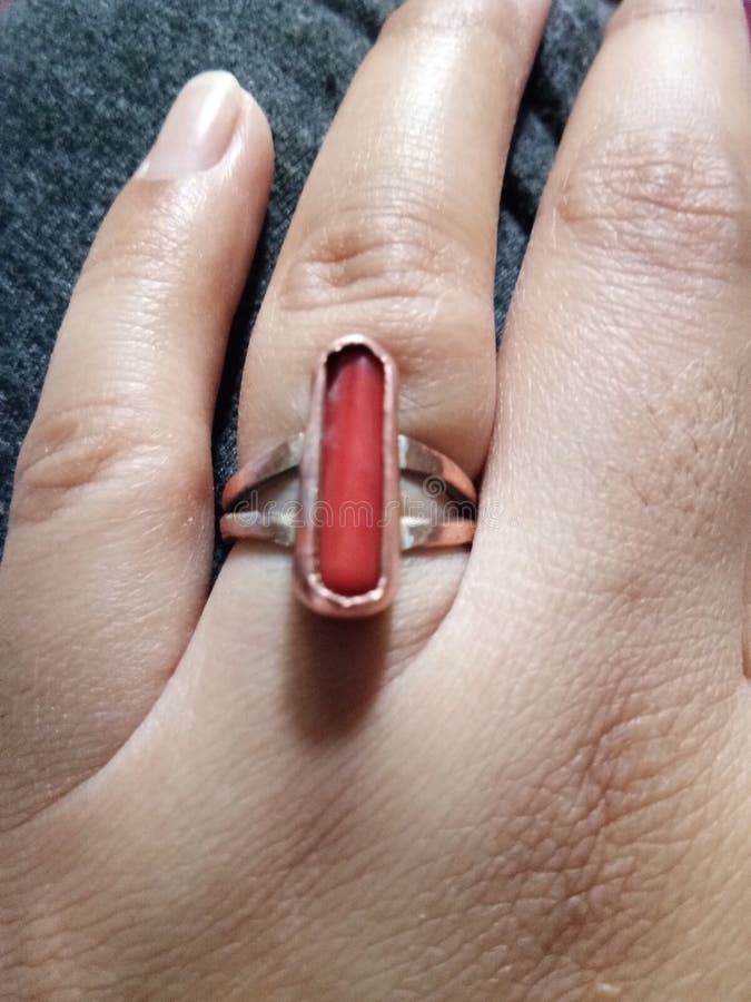 It is Munga Ratan in Red Colour and Suit for Aries. Stock Image - Image of  hand, jewellery: 218399587