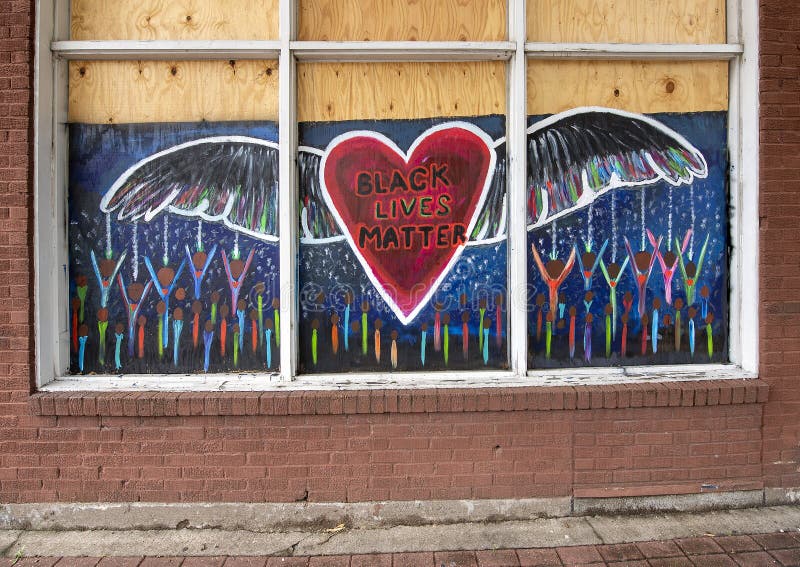 Pictured is one of many murals painted on plywood in Deep Ellum after the George Floyd protests.  The mural features the words `Black Lives Matter` inside a heart with wings.  In May 2020 several businesses in Deep Ellum were vandalized and looted following a protest in downtown Dallas. A peaceful protest over the killing of George Floyd turned violent when a small group clashed with police, broke out windows, looted businesses and set fires.  Because of fear of looting many business put up plywood protection of their doors or windows.  Subsequently artists painted black lives themed murals on the protective plywood all over Deep Ellum.  After the 1850sâ€™ slave liberation in Texas, many slaves from Texas and nearby states built their houses and cropped their land in the future Deep Ellum, which was one of the largest African-American communities. This community holds the most history in the Dallas area.  Today it is composed largely of arts and entertainment venues and is known for it`s graffiti, street art and murals.  It is located near downtown in East Dallas, Texas. Pictured is one of many murals painted on plywood in Deep Ellum after the George Floyd protests.  The mural features the words `Black Lives Matter` inside a heart with wings.  In May 2020 several businesses in Deep Ellum were vandalized and looted following a protest in downtown Dallas. A peaceful protest over the killing of George Floyd turned violent when a small group clashed with police, broke out windows, looted businesses and set fires.  Because of fear of looting many business put up plywood protection of their doors or windows.  Subsequently artists painted black lives themed murals on the protective plywood all over Deep Ellum.  After the 1850sâ€™ slave liberation in Texas, many slaves from Texas and nearby states built their houses and cropped their land in the future Deep Ellum, which was one of the largest African-American communities. This community holds the most history in the Dallas area.  Today it is composed largely of arts and entertainment venues and is known for it`s graffiti, street art and murals.  It is located near downtown in East Dallas, Texas.