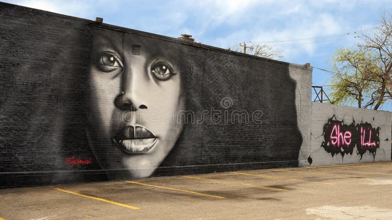 Mural of Erykah Badu by renowned artist Ponchaveli on the outside wall of a building near Fair Park in Dallas, Texas