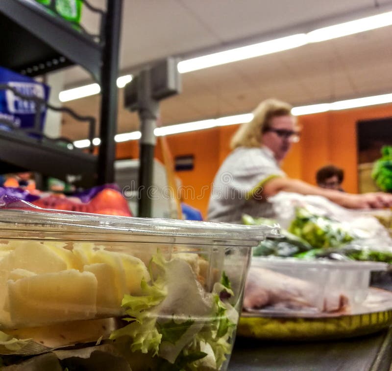 Shopper paying for products at checkout. Foods on conveyor belt at the supermarket royalty free stock photography Shopper paying for products at checkout. Foods on conveyor belt at the supermarket royalty free stock photography
