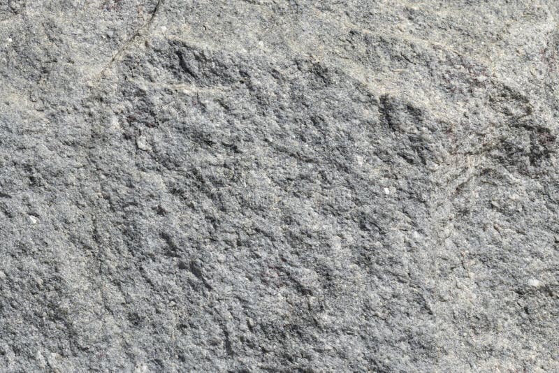 Muren av grå granitsten Naturstenens struktur Bakgrund för arbetsstyckets textur arkivbild