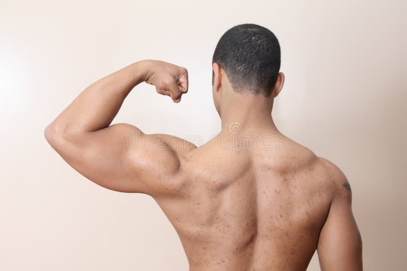 Young male flexing back and arm muscles. Young male flexing back and arm muscles