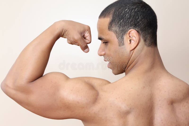 Young male flexing back and arm muscles. Young male flexing back and arm muscles