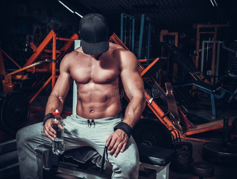 Muscle shaped man tired sitting relaxed stock image Muscle shaped man tired sitting relaxed stock image