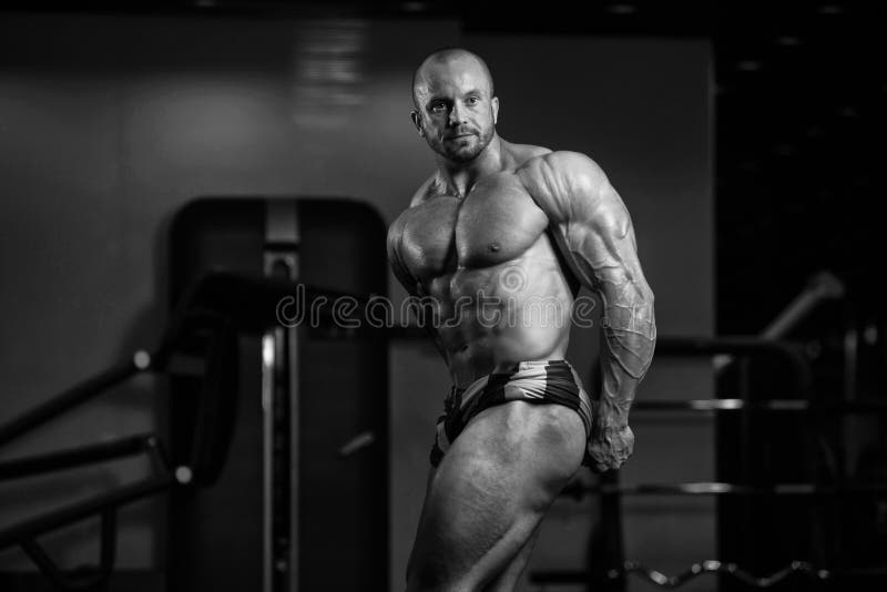 Muscled Male Model Posing In The Gym stock photo Muscled Male Model Posing In The Gym stock photo