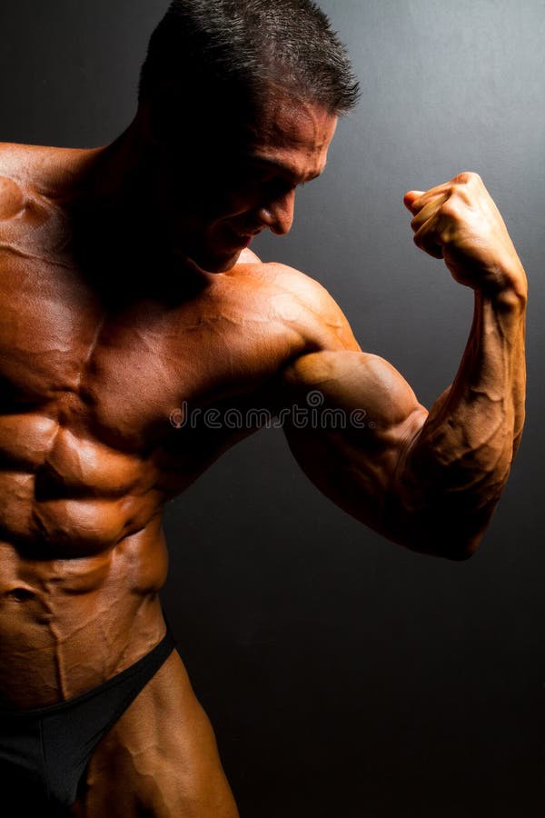 Muscular bodybuilder on black background