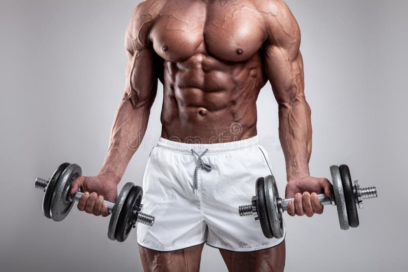 Muscular bodybuilder guy doing exercises with dumbbell stock photo Muscular bodybuilder guy doing exercises with dumbbell stock photo