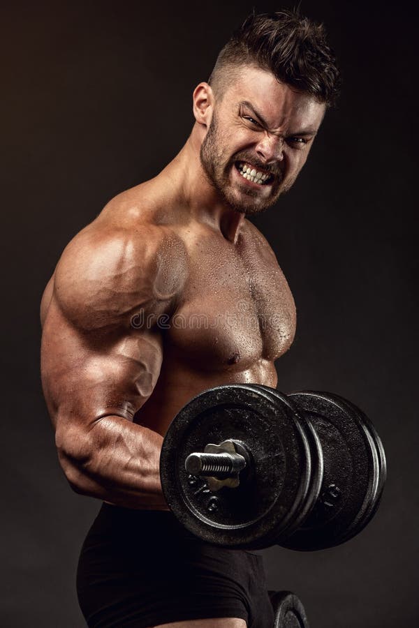 hard workout. Muscular black man doing exercises with dumbbells