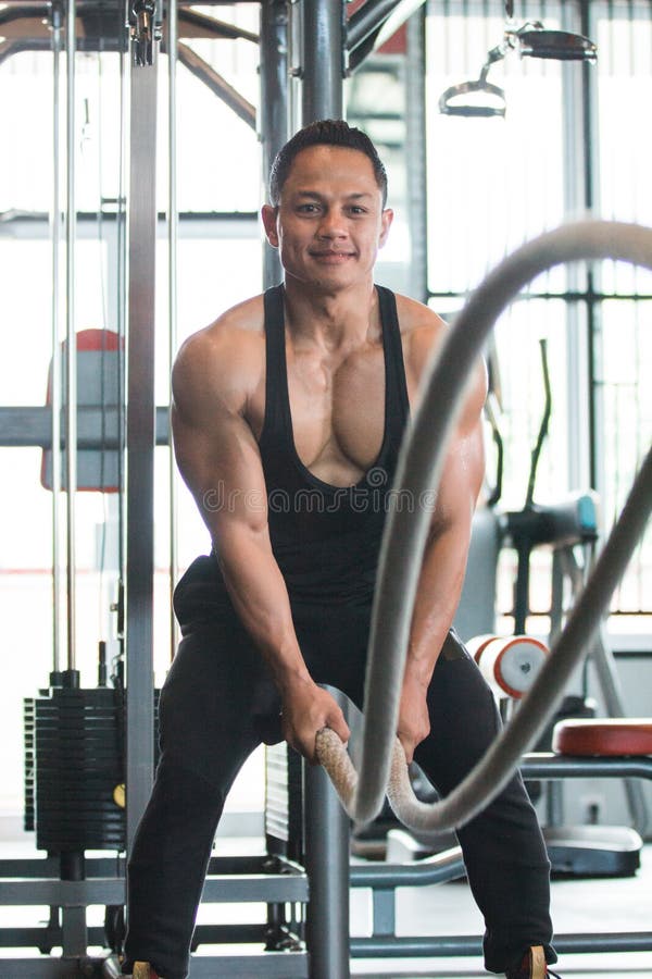 Muscular man is doing battle rope exercise royalty free stock image Muscular man is doing battle rope exercise royalty free stock image