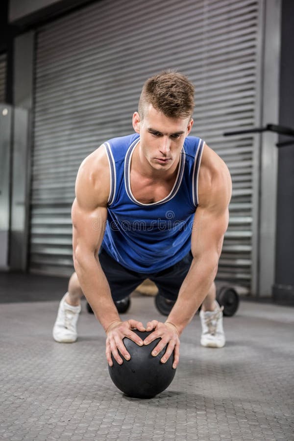 Muscular Man Doing Pull Up with Medicine Ball Stock Photo Image of