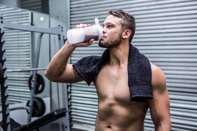 Muscular man drinking protein cocktail stock image Muscular man drinking protein cocktail stock image
