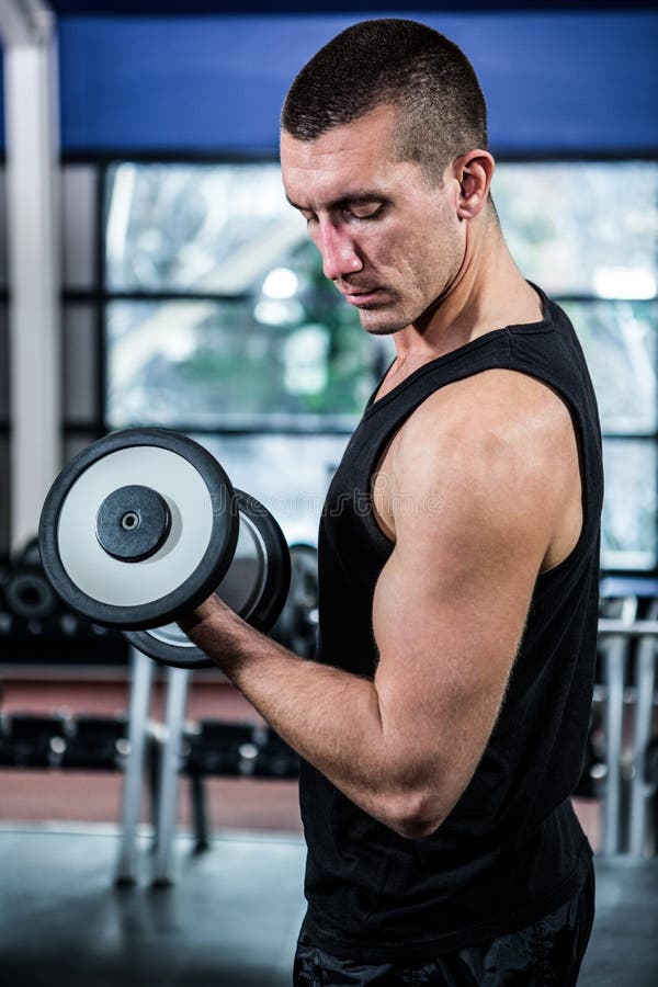 Strong Athletic Man With Dumbbell Showes Muscular Body 