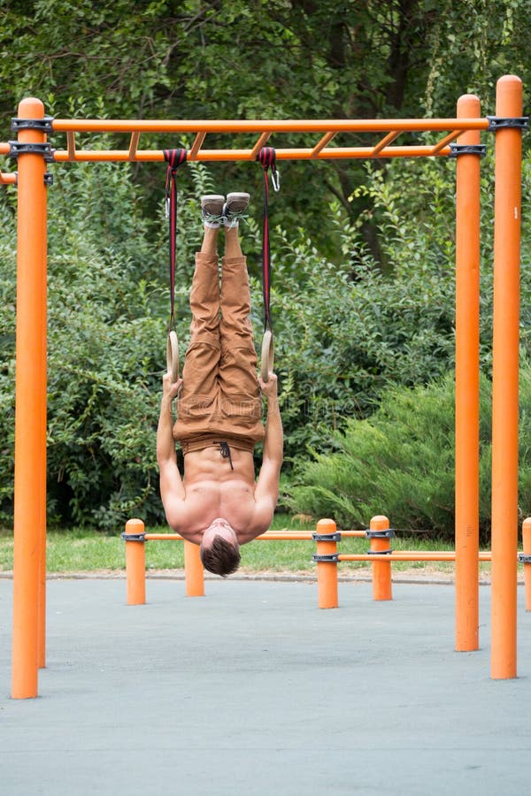 Muscular Man Exercising on Outdoor Gymnastic Ring. Stock Image Image