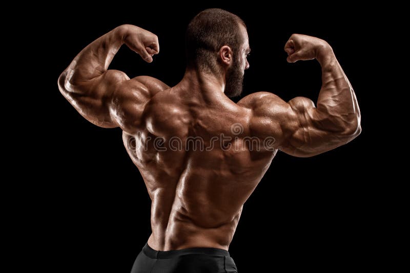 Muscular man showing muscles isolated on the black background. Strong male  naked torso abs Stock Photo