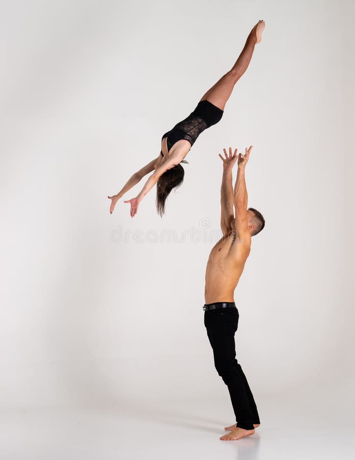 Duo Of Male And Female Acrobats Showing Hand To Hand Trick, Isolated On  White Stock Photo, Picture and Royalty Free Image. Image 141734000.