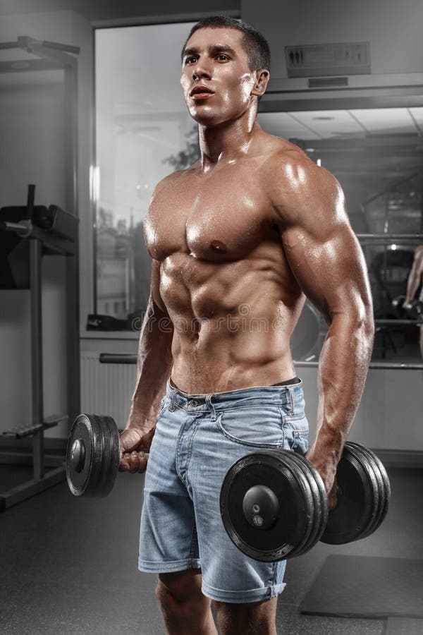 Muscular man working out in gym doing exercises with barbell, strong male naked torso abs stock photos Muscular man working out in gym doing exercises with barbell, strong male naked torso abs stock photos