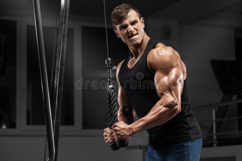 Perfectly Sculpted Strength. A Muscular Man Looking Down. Stock Photo,  Picture and Royalty Free Image. Image 194676756.