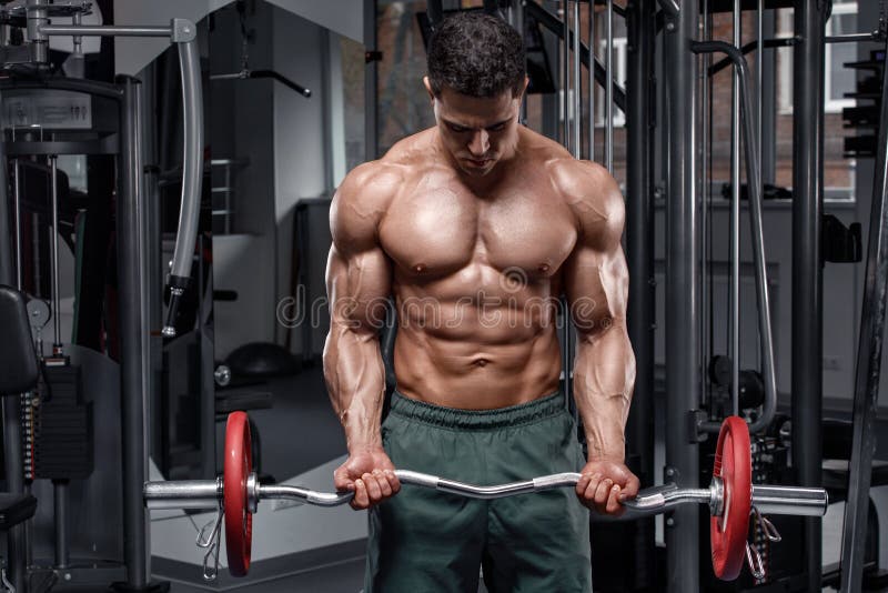 Sporty man posing in gym stock photo. Image of abdominal 